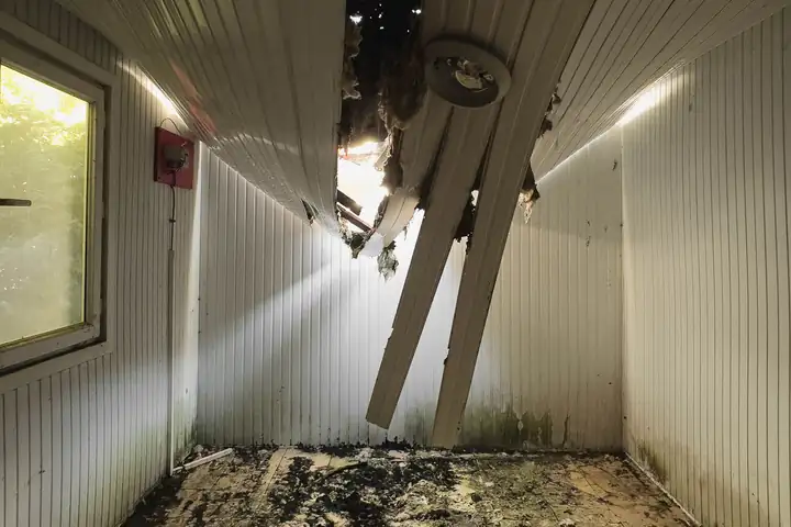 Room interior with a collapsed ceiling and debris on the floor