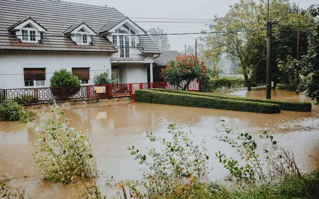 Suburban house surrounded by floodwater after heavy rain