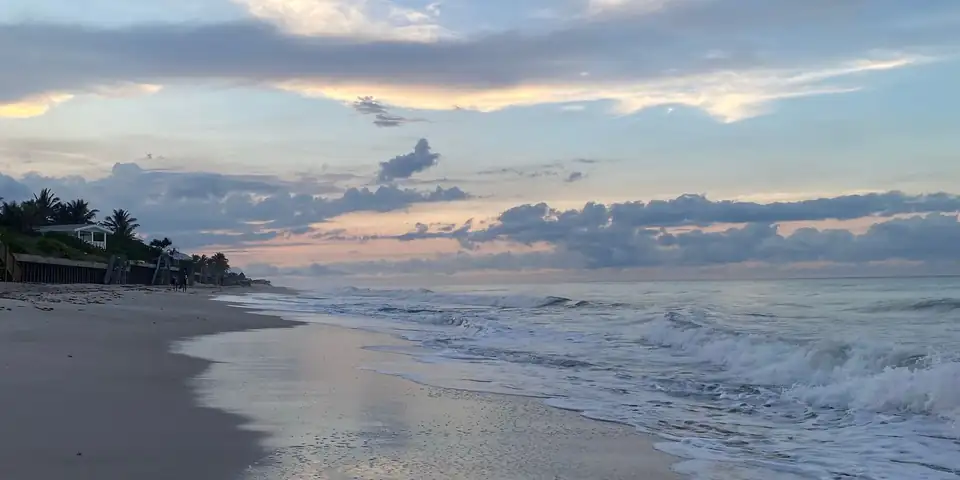 Vero Beach shoreline at sunset with waves on the sand